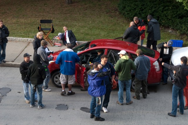 Lots of people gathered around the star Prius, getting it ready for the day's shooting.